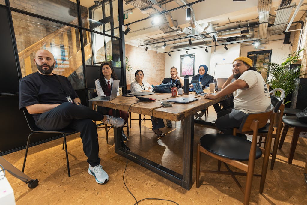 Diverse team engaged in a collaborative meeting in a contemporary office space.